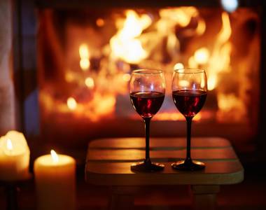 Red wine glasses in front of the fireplace